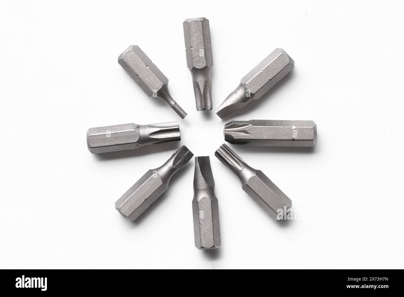 Different screwdriver bits on white background, top view Stock Photo
