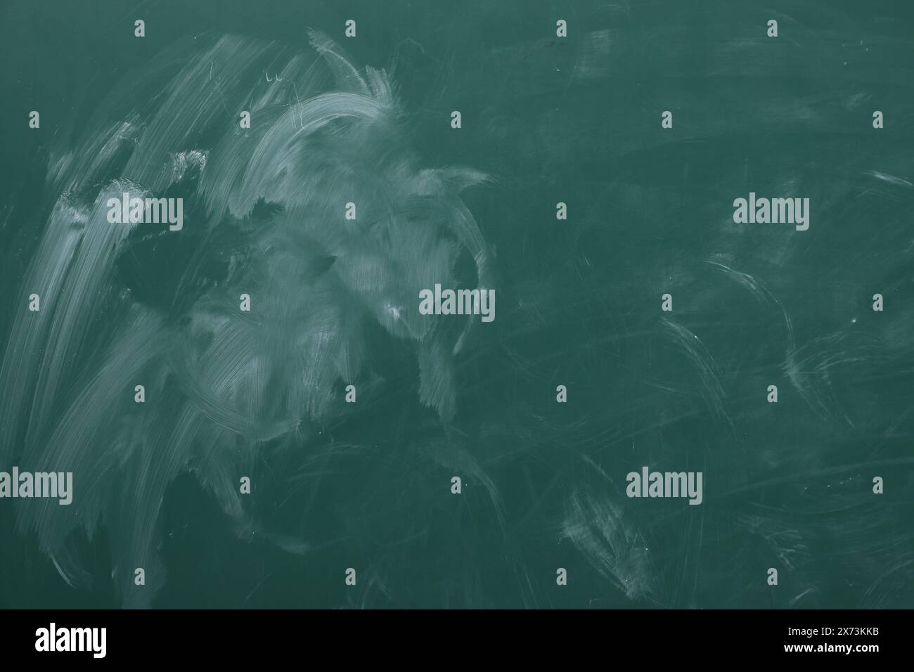 Chalk rubbed out on green chalkboard as background, closeup. Space for text Stock Photo