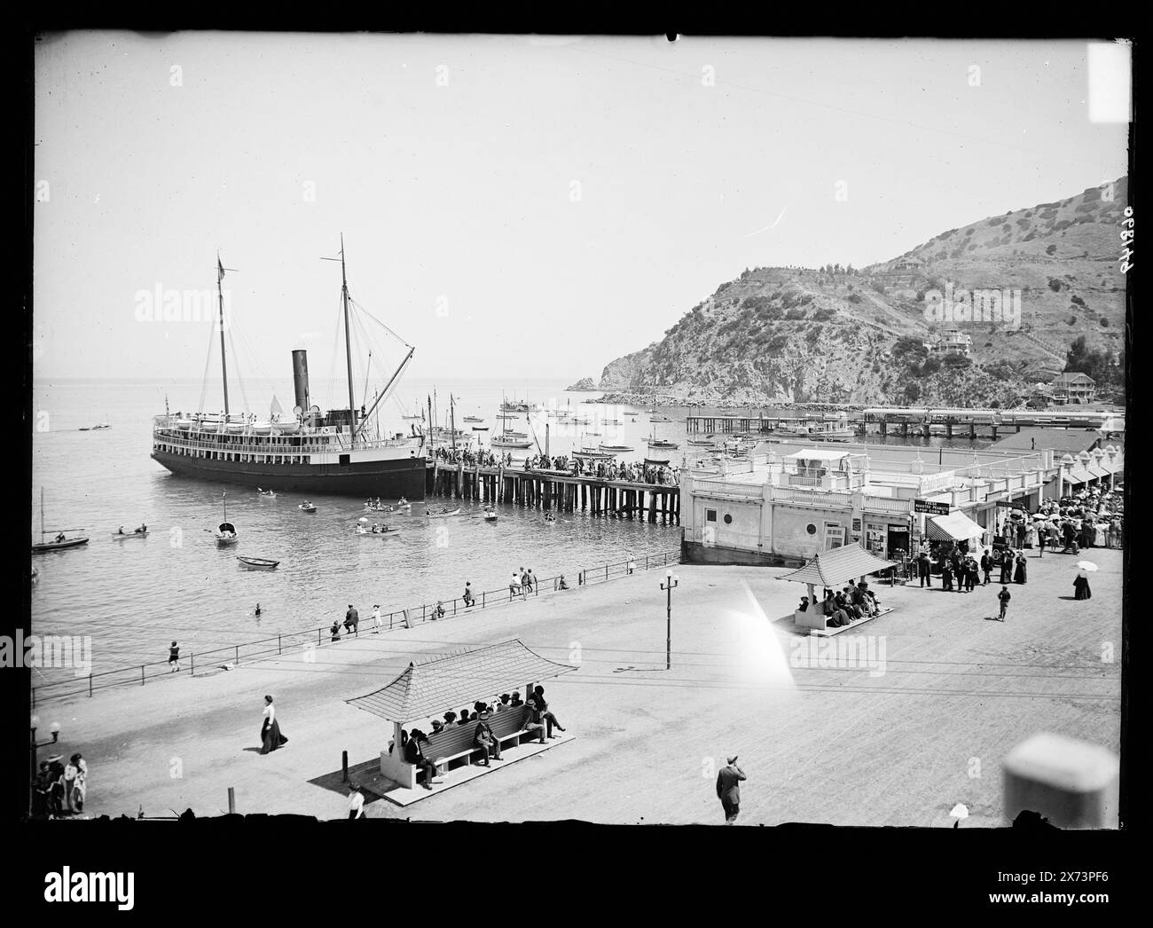 Steamship at pier by boardwalk, Avalon, Catalina Island, Calif., Title devised by cataloger., '4506' on negative., Detroit Publishing Co. no. 068149., Gift; State Historical Society of Colorado; 1949,  Ships. , Harbors. , Boardwalks. , Piers & wharves. , United States, California, Santa Catalina Island. , United States, California, Avalon. Stock Photo
