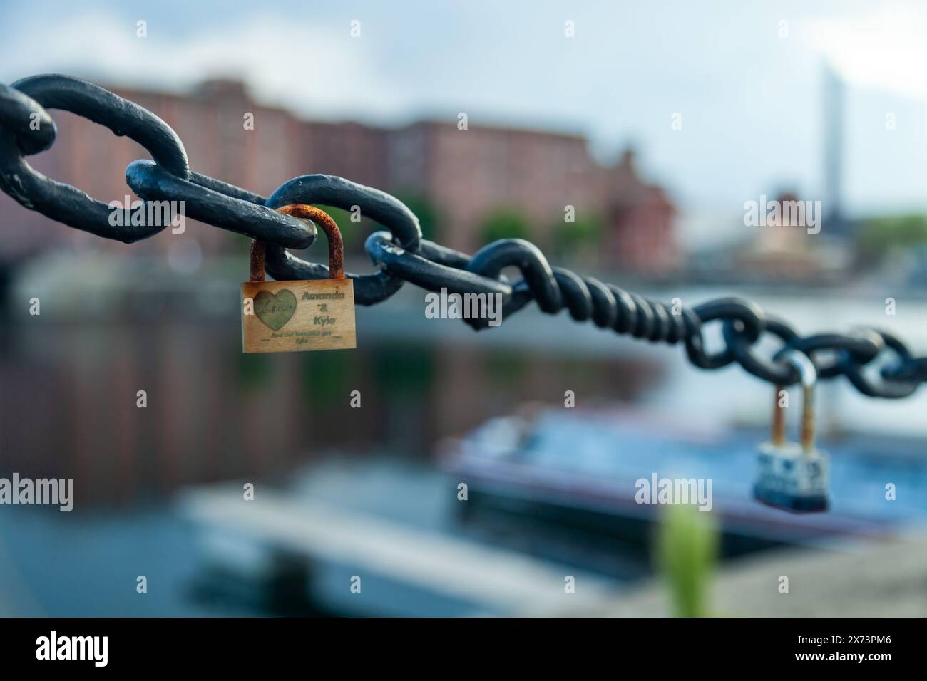 Padlocks on chain along Salthouse Dock in Liverpool. Stock Photo
