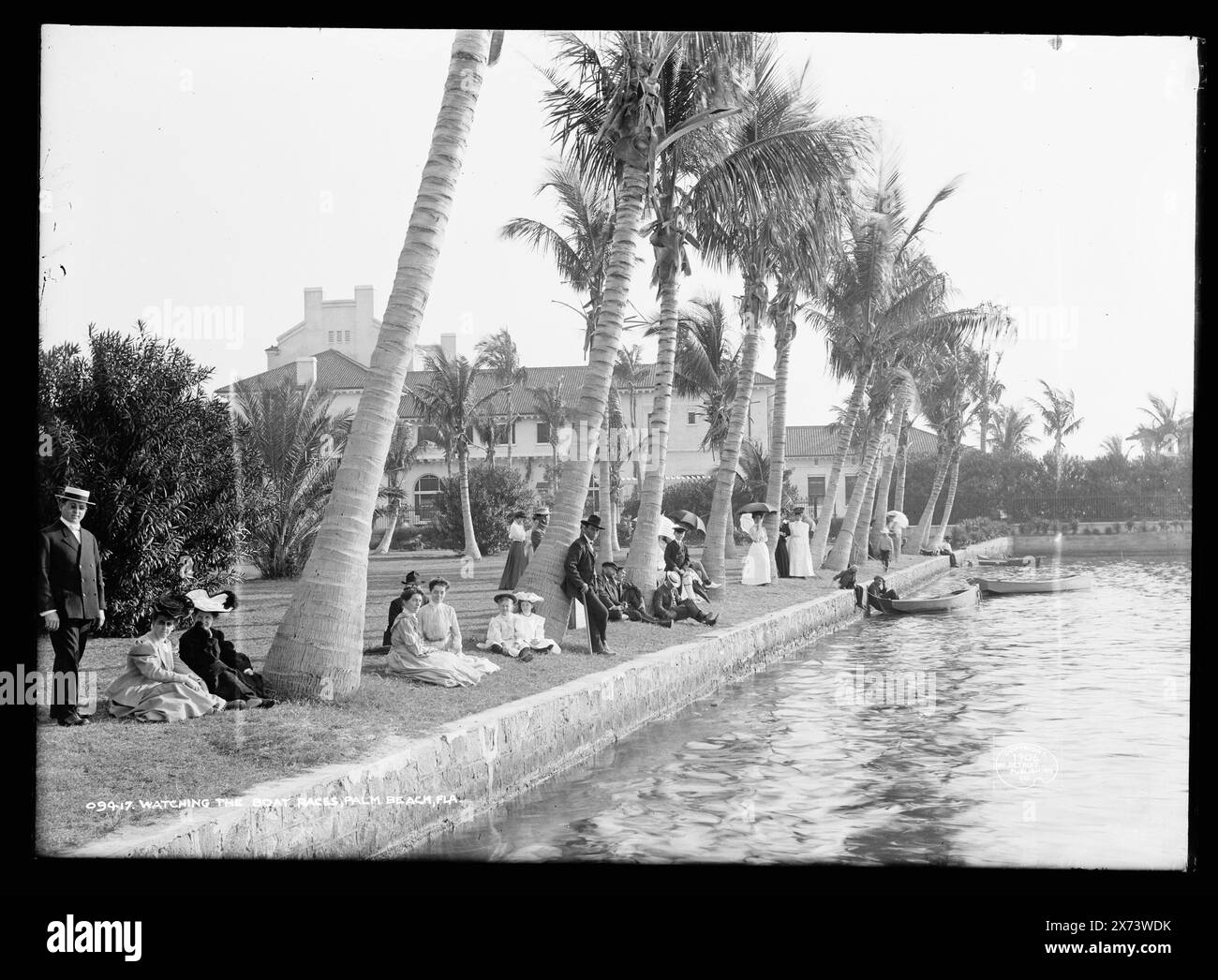 Watching the boat races, Palm Beach, Fla., Title in Detroit, Catalogue P (1906) continues: Whitehall [Flagler mansion] in background., Also available as photographic print in LOT 9081; copy negative LC-USZ62-96359 (b&w film copy neg.)., 'M-15' on negative., Detroit Publishing Co. no. 09417., Gift; State Historical Society of Colorado; 1949,  Dwellings. , Crowds. , Waterfronts. , United States, Florida, Palm Beach. Stock Photo