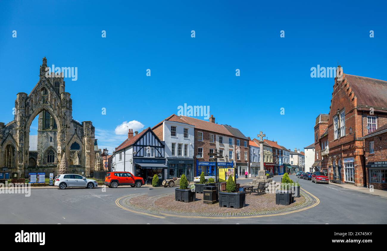Shops and Howden Minster on Market Place, Howden, Yorkshire, England, UK Stock Photo