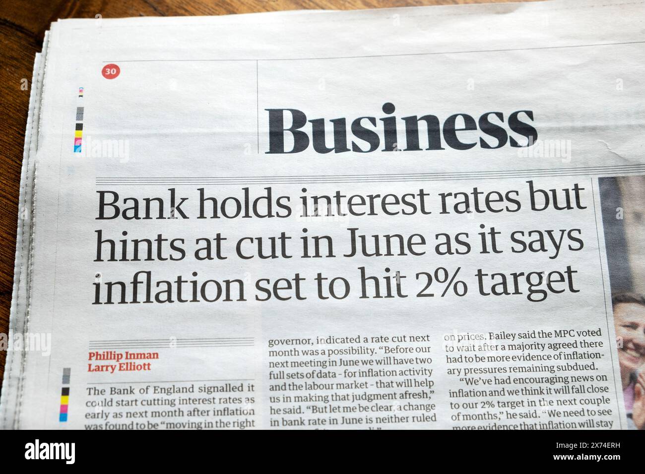 'Bank holds interest rates but hints at cut in June as it says inflation set to hit 2% target' Guardian newspaper headline Bank of England 10 May 2024 Stock Photo