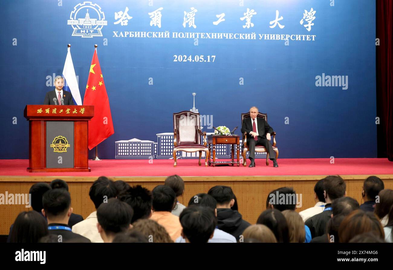 Harbin, China. 17th May, 2024. Russian President Vladimir Putin, right, listens to remarks by HIT Chairman Xiong Sihao during a visit with faculty and students at the Harbin Institute of Technology, May 17, 2024, in Harbin, China. The university was founded in 1920 as Harbin Sino-Russia Industrial School. Credit: Kremlin Pool/Russian Presential Press Service/Alamy Live News Stock Photo