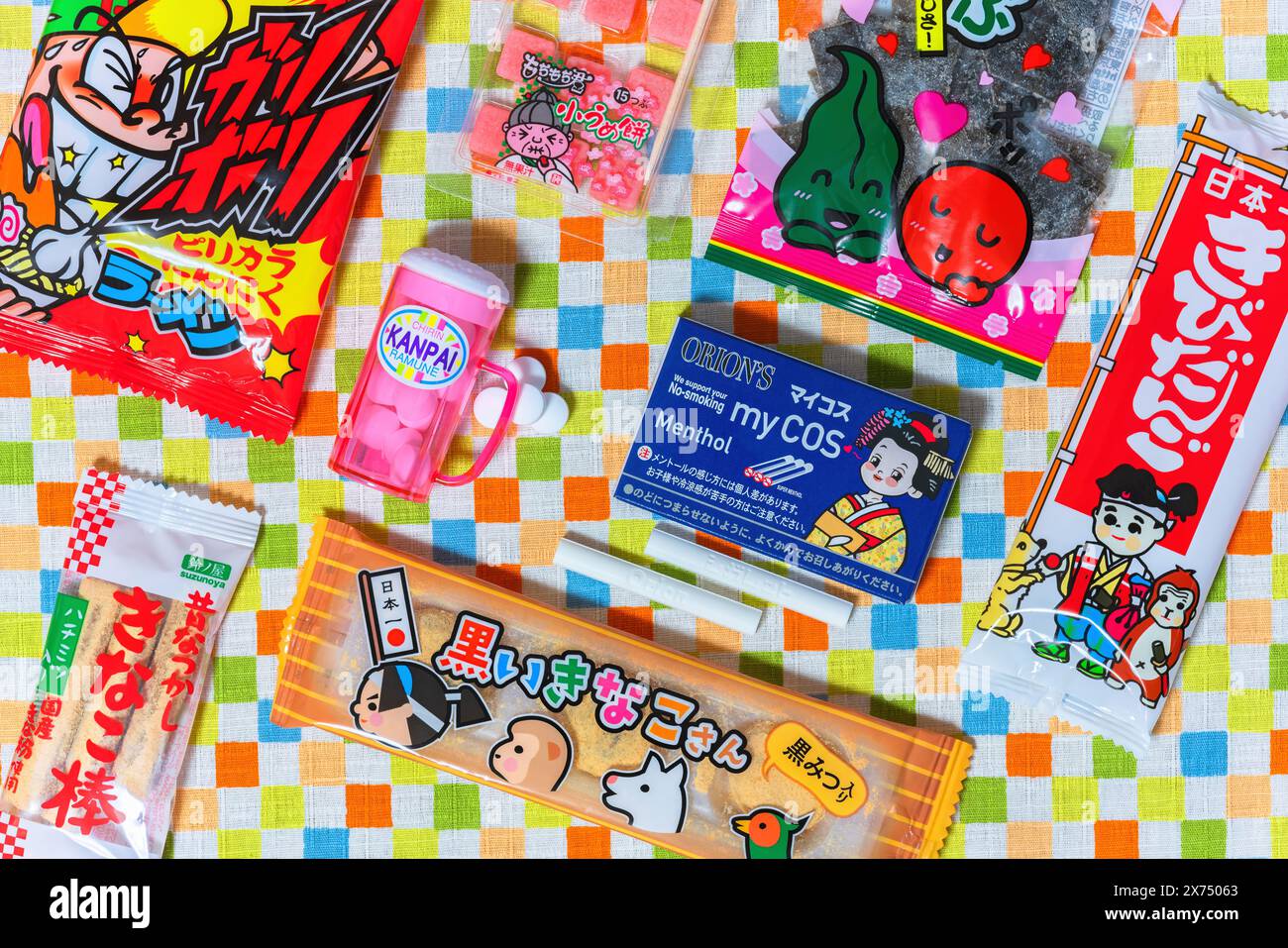 tokyo, japan - fev 17 2024: Top view photo of various Japanese dagashi kids confectioneries featuring cocoa cigarettes and a beer mug,kinako sticks, p Stock Photo