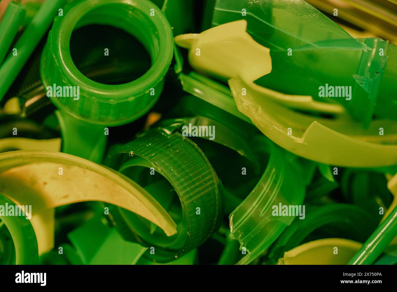Recycling green plastic bottle caps to be reused for manufacturing. New
