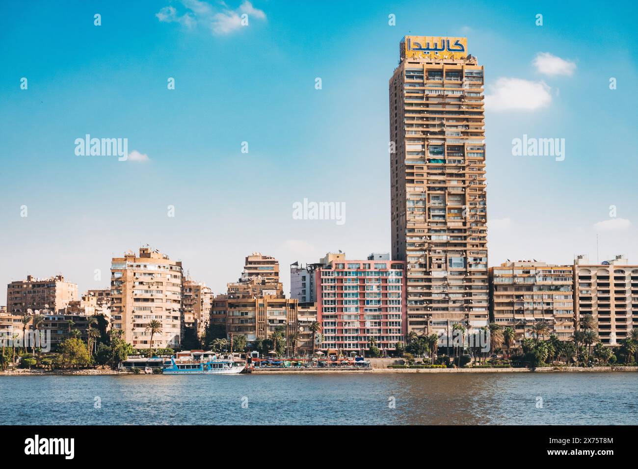 Nile riverfront in Cairo featuring high-rise residential towers, a long ...