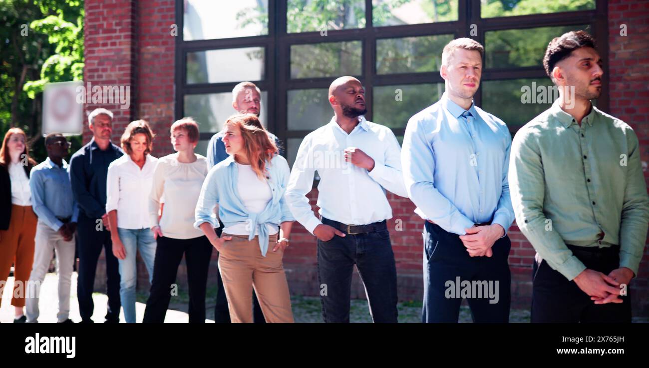 Queue Outdoors. Business People Waiting In Line Stock Photo