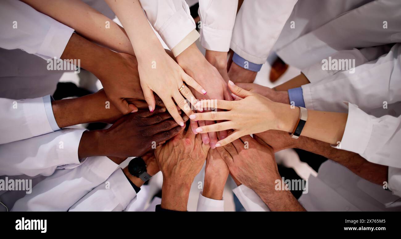 Medical Team Stacking Hands Against In Hospital Stock Photo