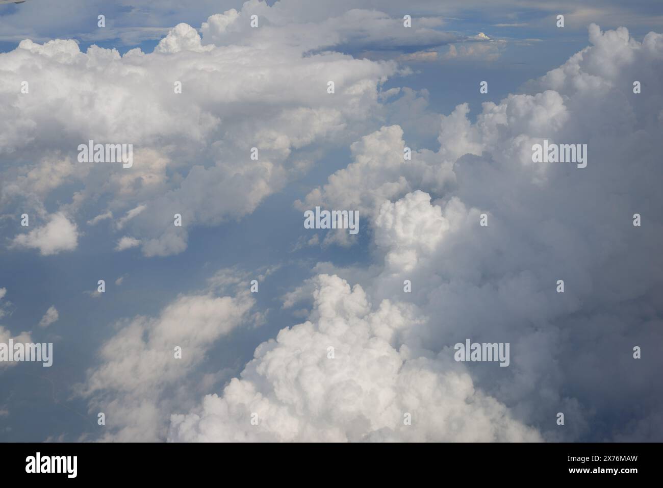 Aerial view seen over clouds from aircraft Stock Photo - Alamy