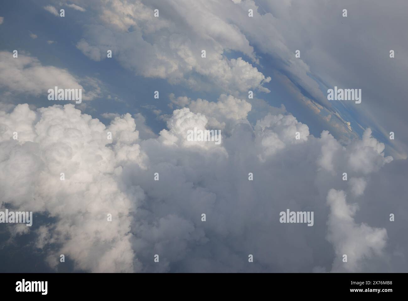Aerial view seen over clouds from aircraft Stock Photo - Alamy