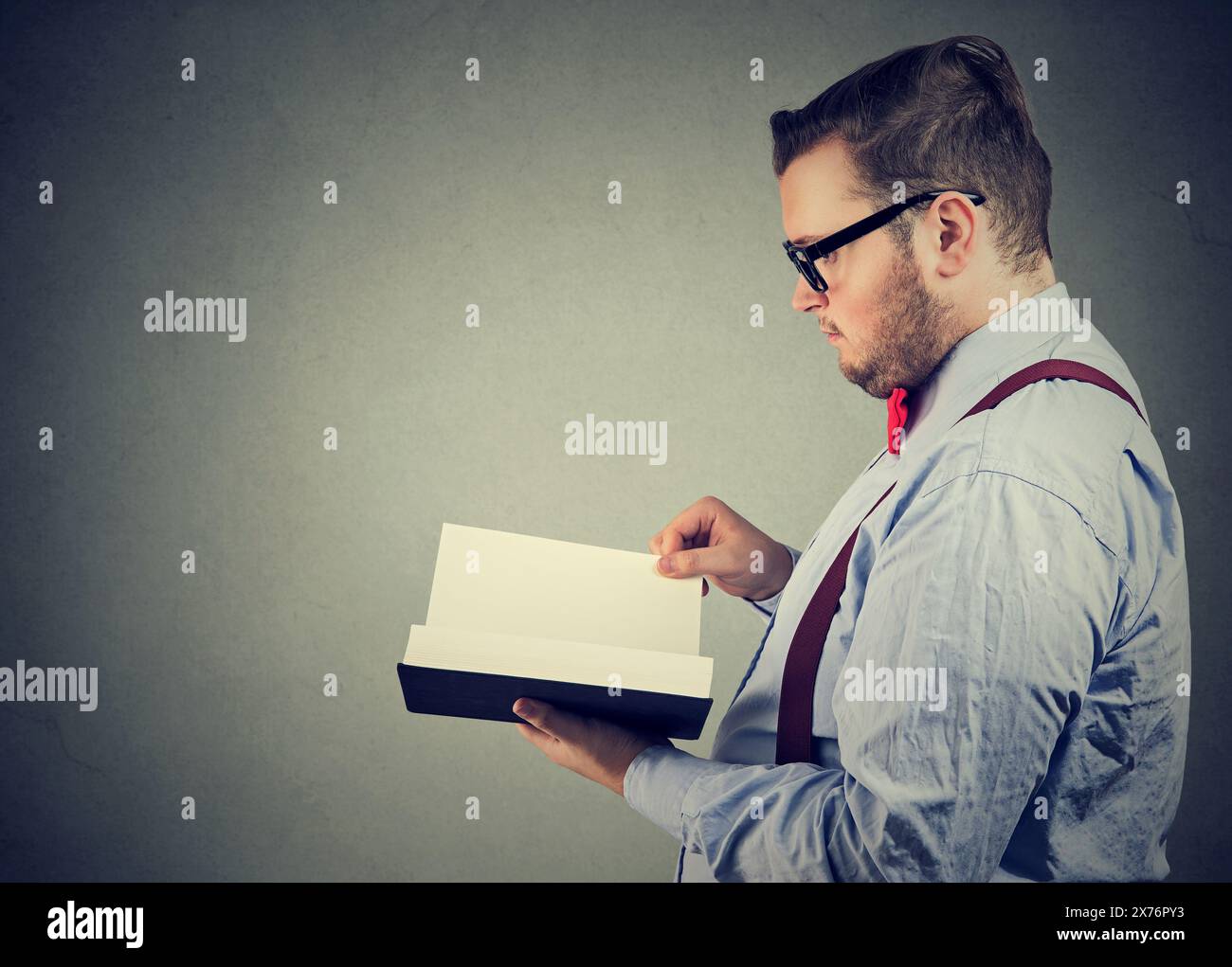 Side profile of a businessman reading a book Stock Photo - Alamy