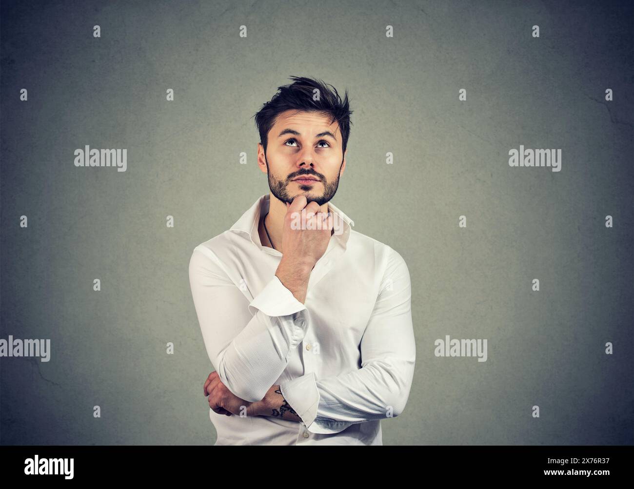 Portrait of a thinking serious man looking up Stock Photo