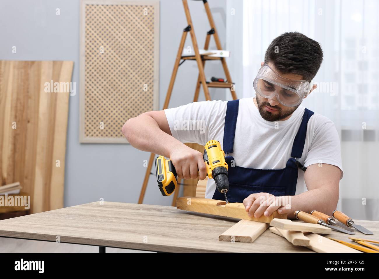 Young man using drill machine hi-res stock photography and images - Alamy