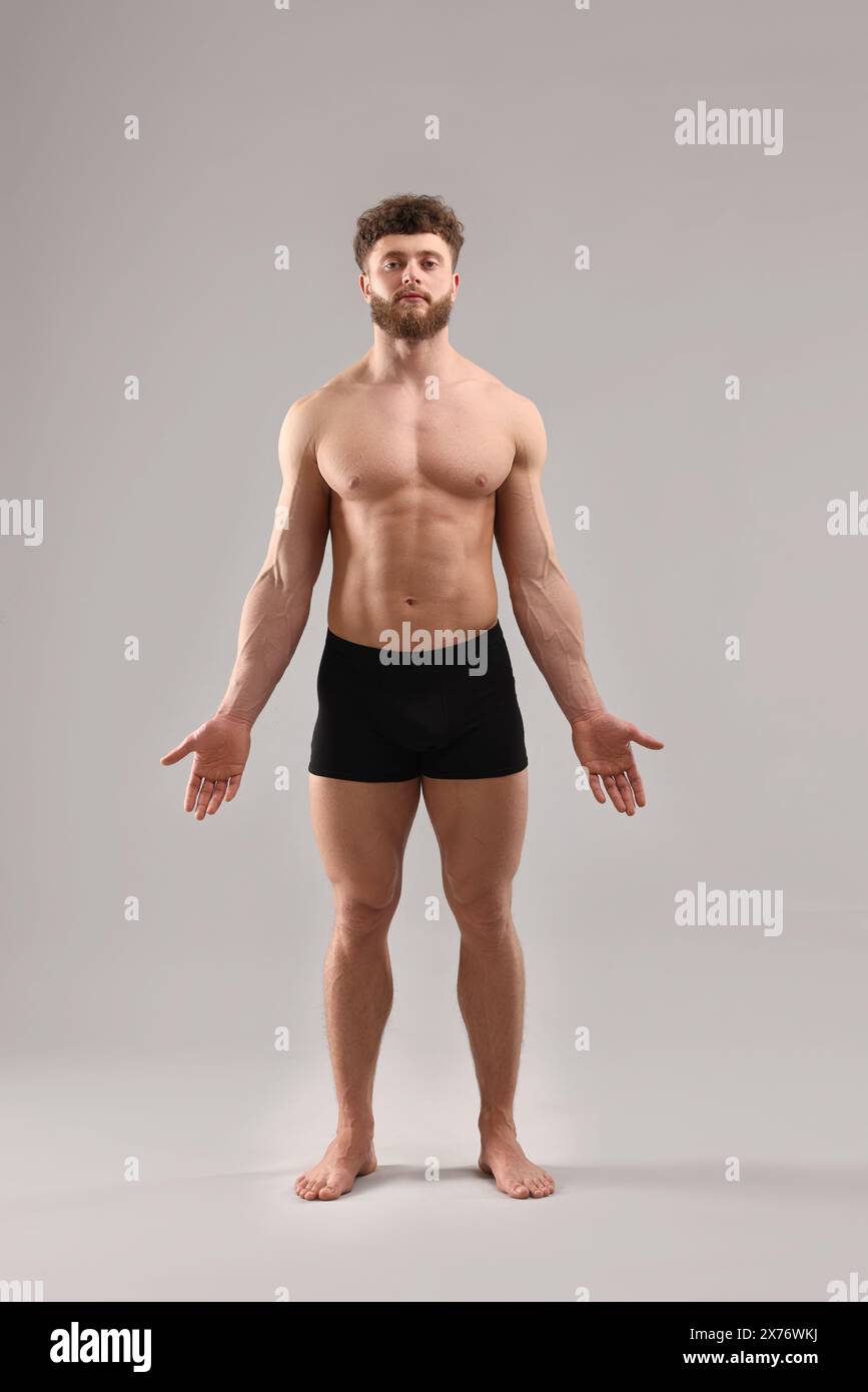 Handsome man with muscular body on light grey background Stock Photo