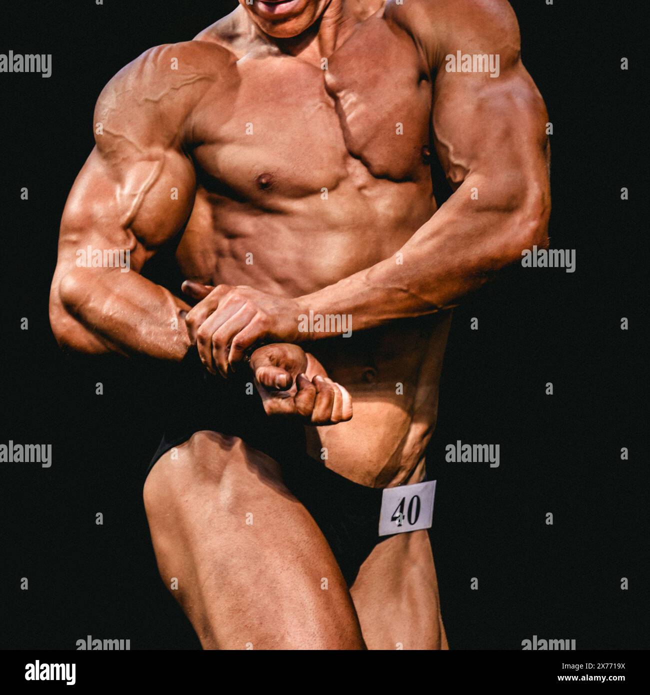 bodybuilder athlete show side chest pose for bodybuilding competition Stock Photo