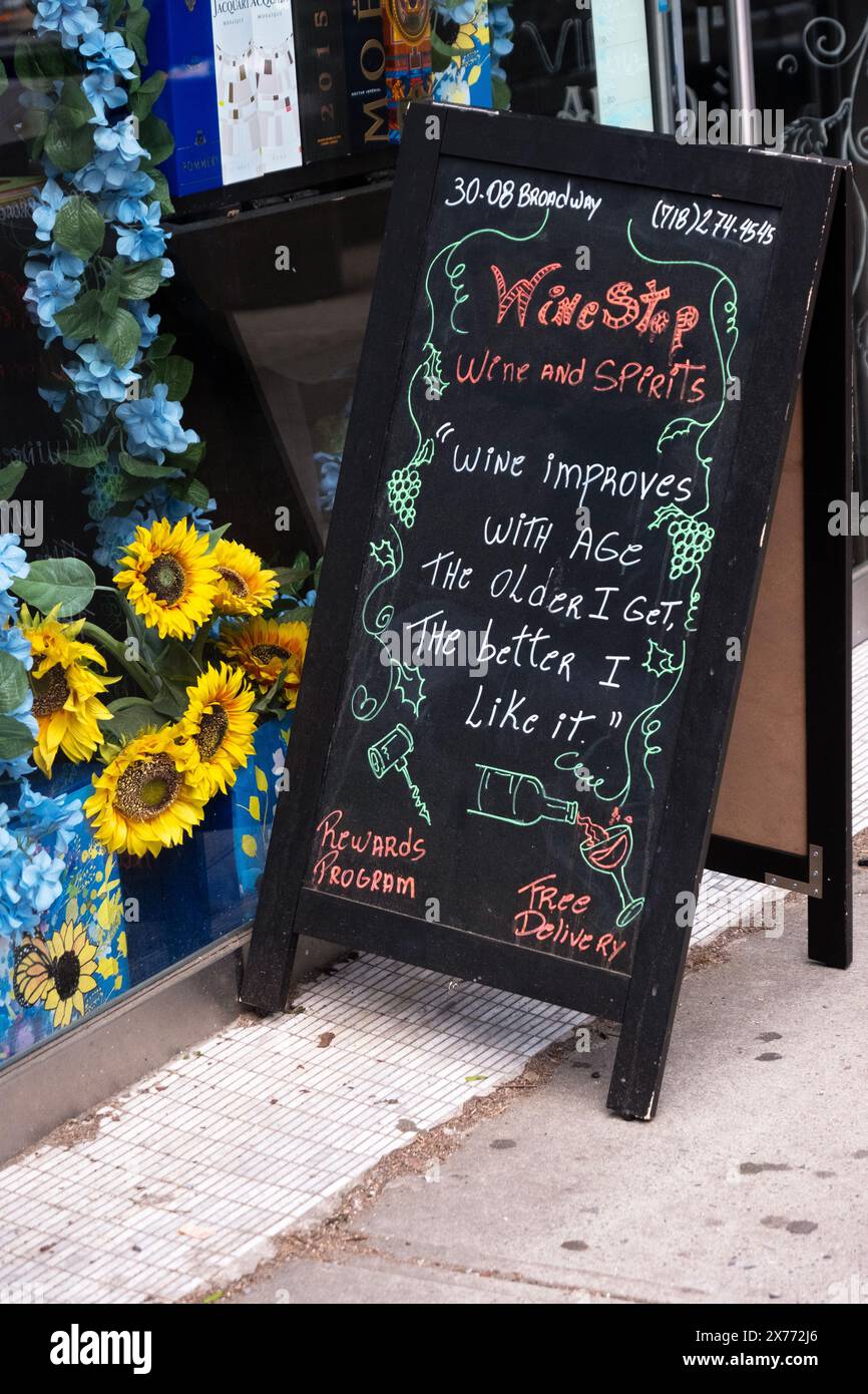 A funny chalk on blackboard sign outside the Wine Shop NYC with a joke about aging. In Astoria Queens, New Yokr. Stock Photo