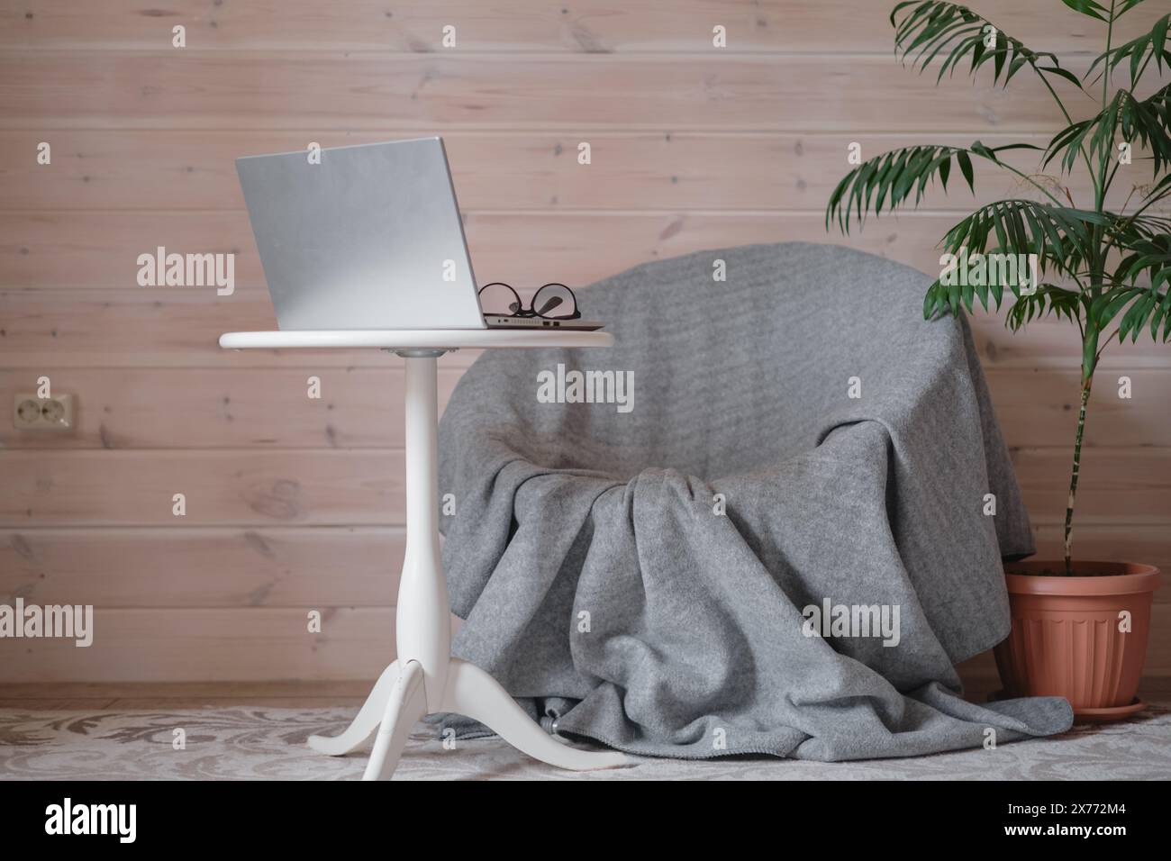 The concept of an equipped cozy workplace in the house for remote work, minimalism and comfort of a psychoanalyst’s workplace, Scandinavian minimalist Stock Photo