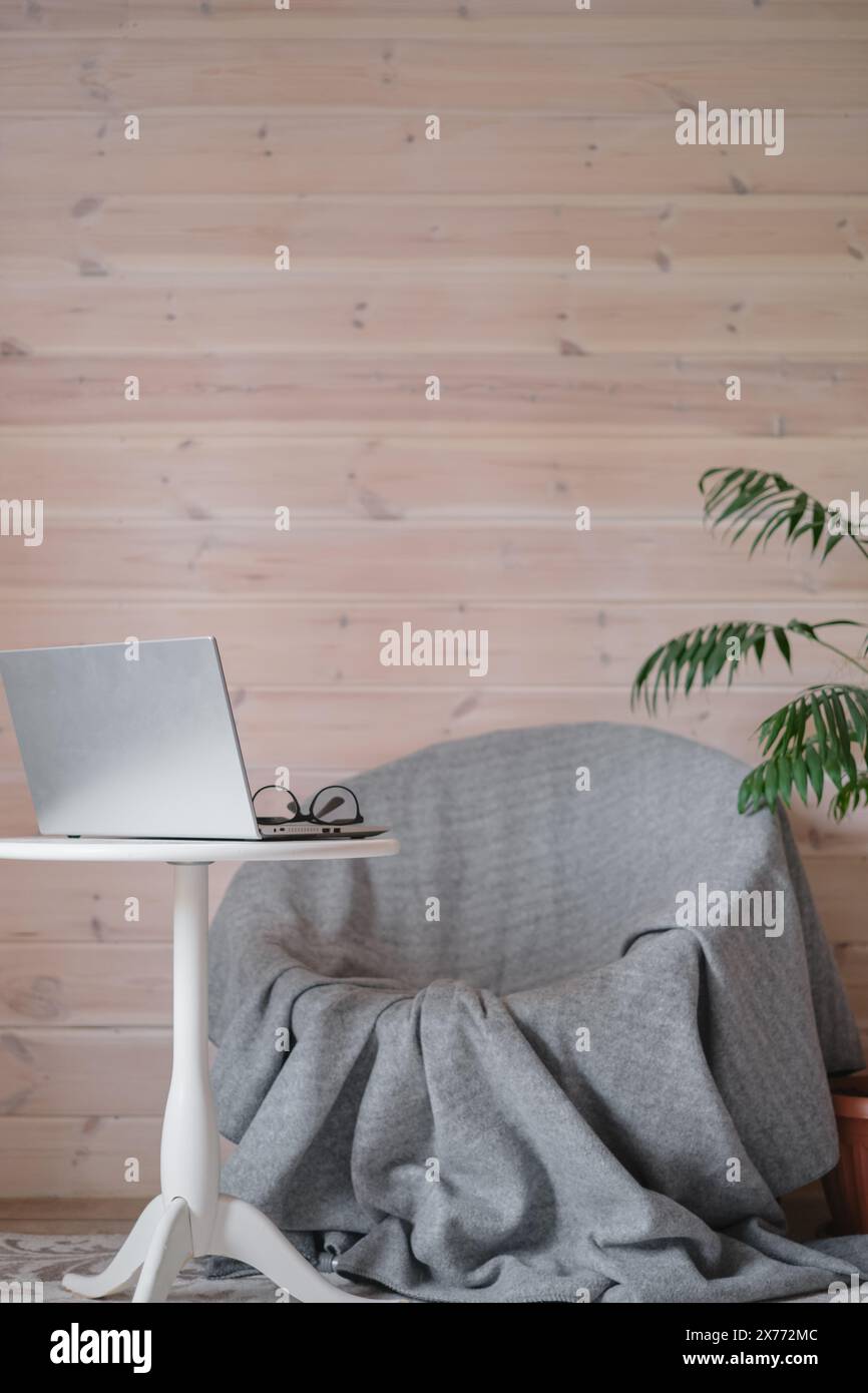 Vertical photograph with the concept of a cozy workplace in a home for remote work, minimalism and comfort of a psychoanalyst’s workplace, Scandinavia Stock Photo
