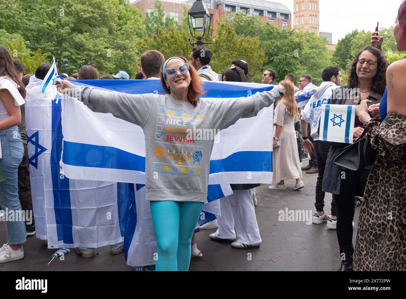 During a pro Israel rally in Washington Square PArk a proud Jewish girl poses with an Israeli flag. Stock Photo