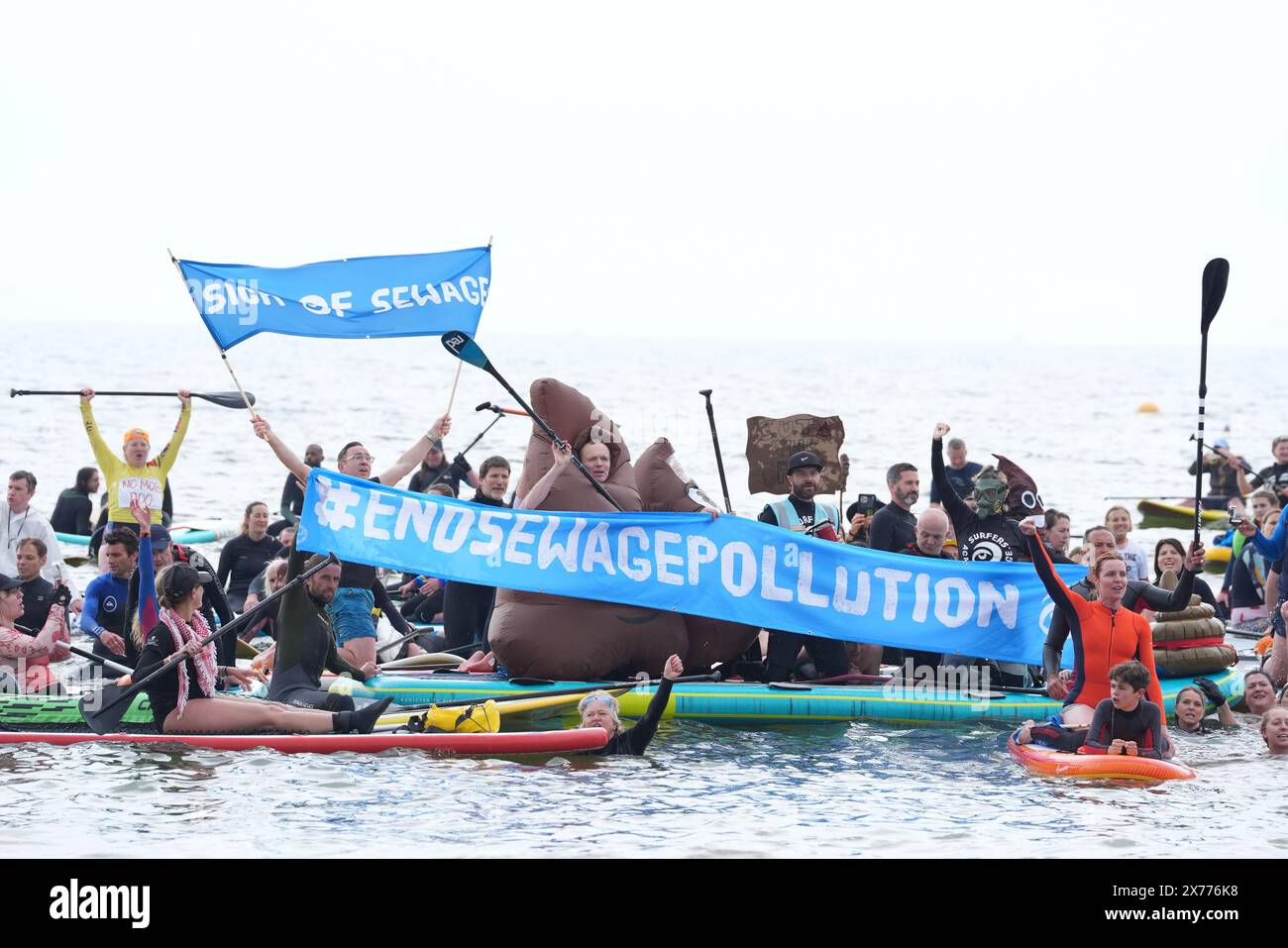 Protesters during a Surfers Against Sewage (SAS) Paddle-Out Protest in Brighton. Protests have been coordinated nationwide by Surfers Against Sewage, who are calling for an end to the sewage discharges plaguing the UK's rivers and seas, as sewage overflows continue to have a devastating impact on ecological and human health. Picture date: Saturday May 18, 2024. Stock Photo