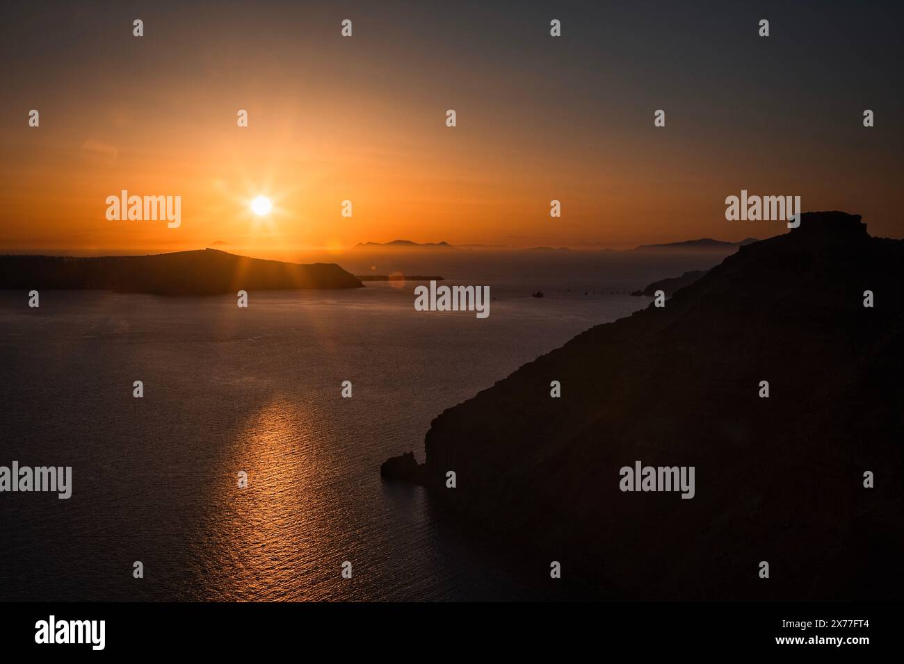 The cruise ships have set sail as the sun sets over the Aegean Sea at Santorini, Greece. Stock Photo