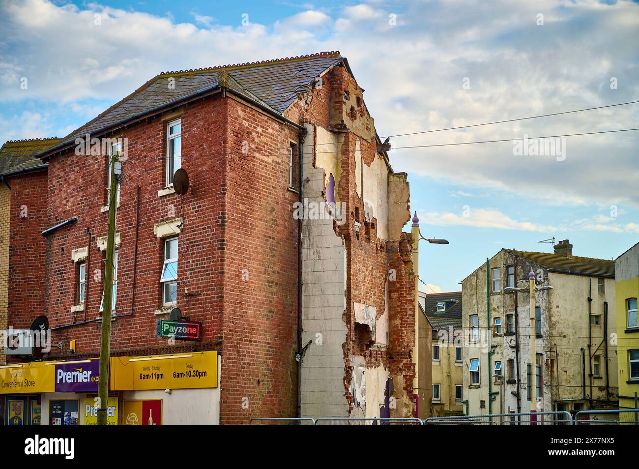 Shop located in rundown area next to demolished site Stock Photo