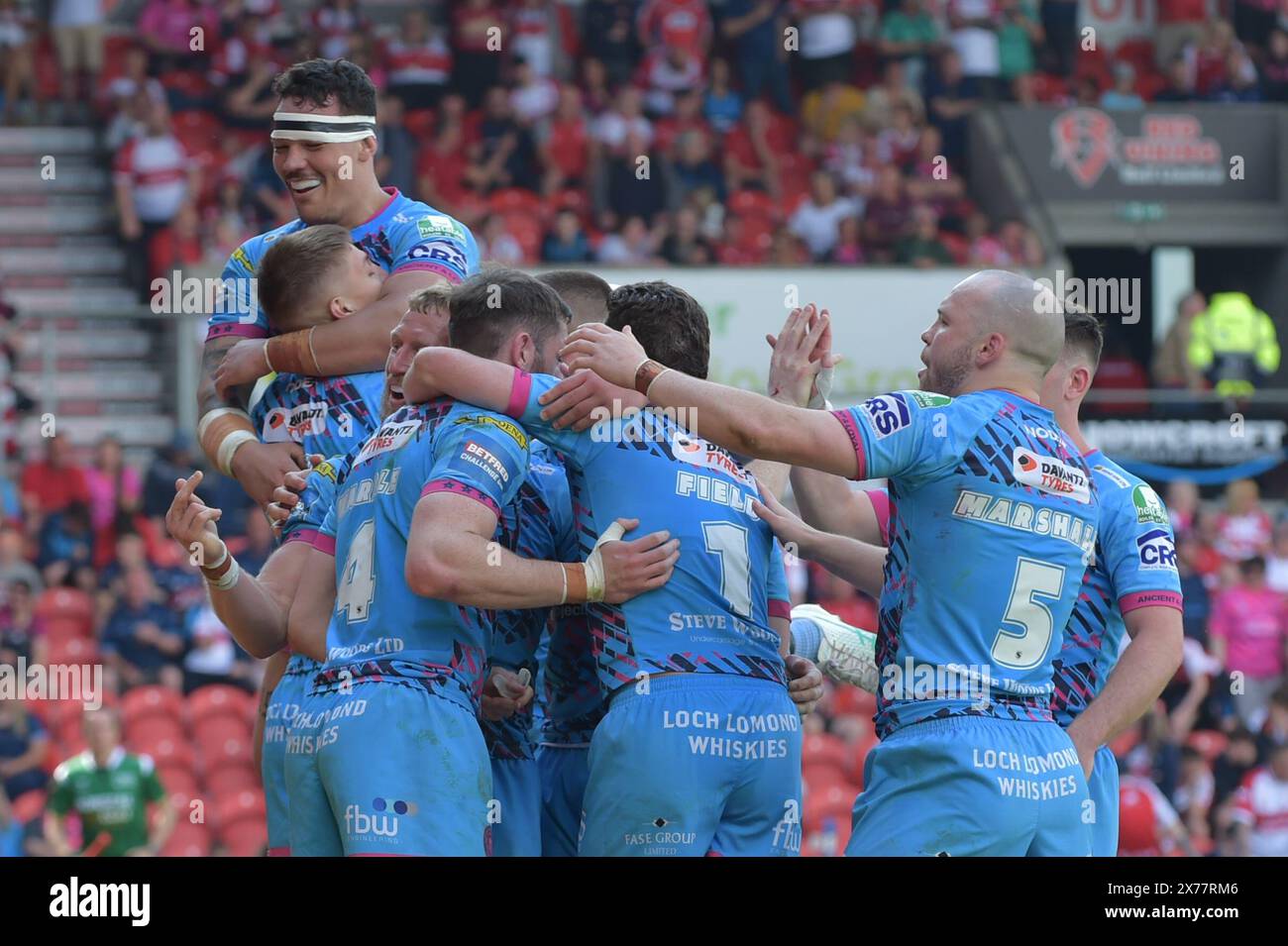 Tyler Dupree of Wigan Warriors leads the celebrations during the