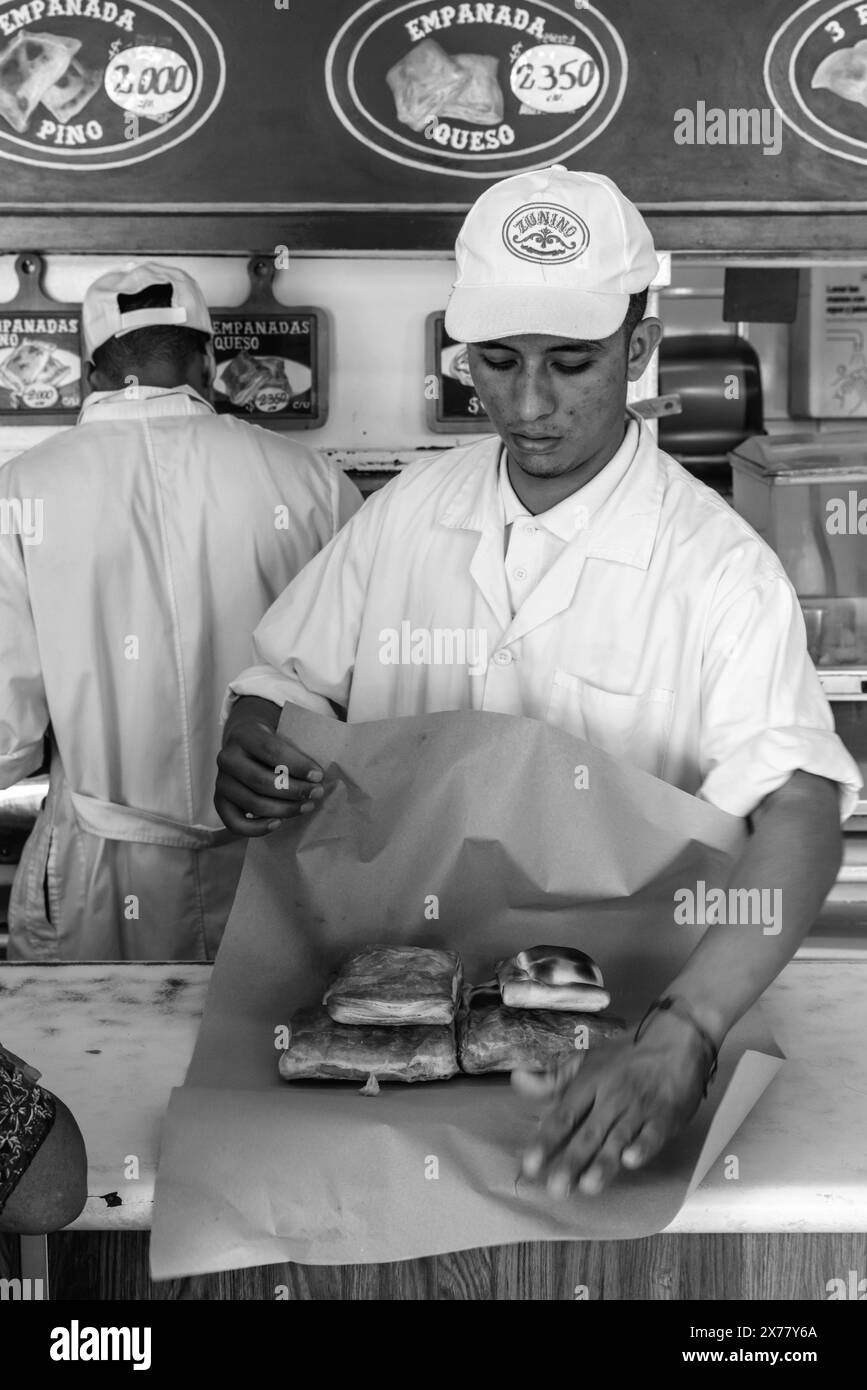 A Young Man Wraps Empanadas In The Emporio Zunino, Santiago, Chile. Stock Photo