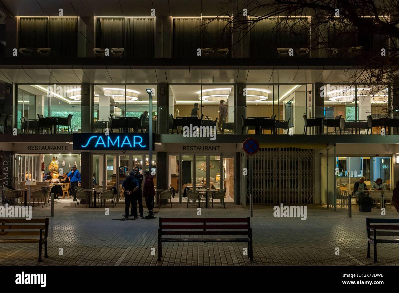 Cala Millor, Spain; march 30 2024: Main facade of a restaurant in the Majorcan town of Cala Millor, at night Stock Photo