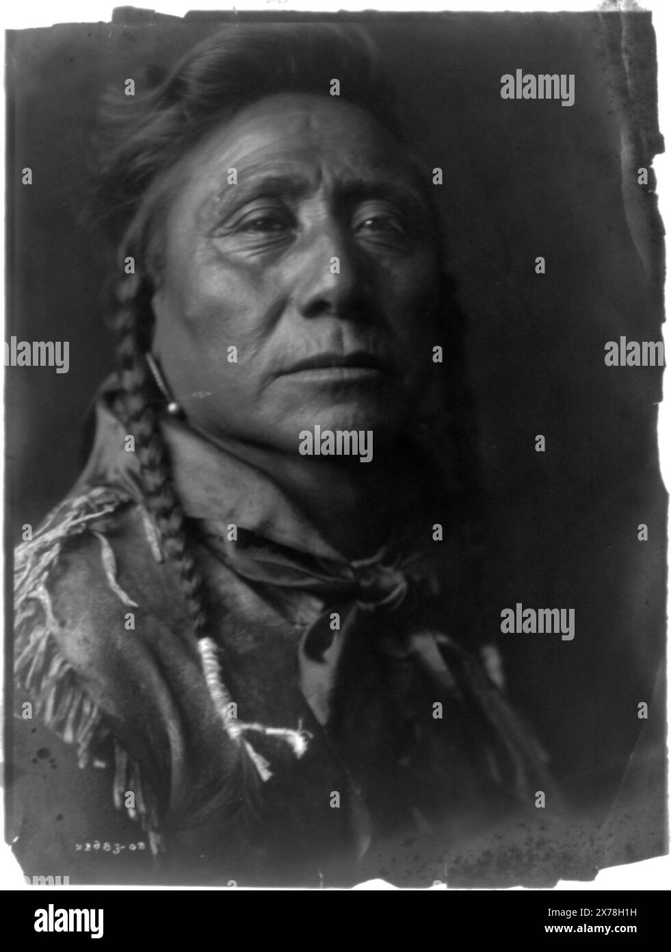 Coups Well Known Apsaroke, Curtis no. 2683-08., Forms part of: Edward S. Curtis Collection ., Published in: The North American Indian / Edward S. Curtis. [Seattle, Wash.] : Edward S. Curtis, 1907-30, Suppl., v. 4, pl. 144.. Indians of North America, 1900-1910. , Crow Indians, 1900-1910. , Braids (Hairdressing), 1900-1910. Stock Photo