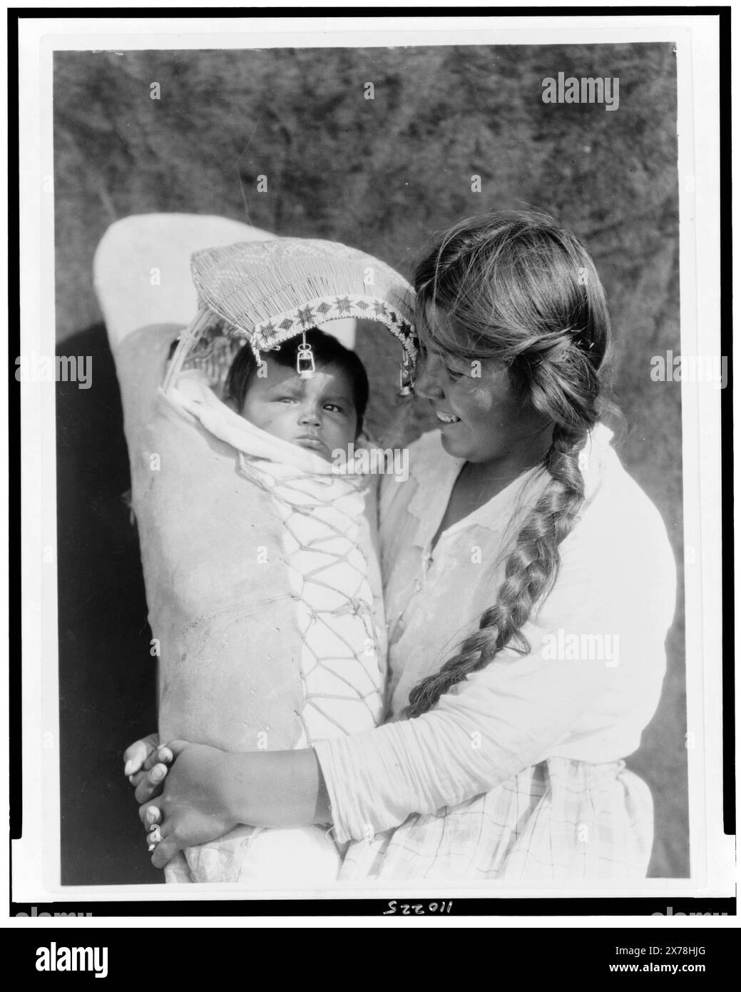 Achomawi mother and child, Edward S. Curtis Collection., Curtis no. 3941., Published in: The North American Indian / Edward S. Curtis. [Seattle, Wash.] : Edward S. Curtis, 1907-30 suppl., v. 13, p. 136.. Indians of North America, California, 1920-1930. , Achomawi Indians, 1920-1930. , Mothers & children, California, 1920-1930. Stock Photo