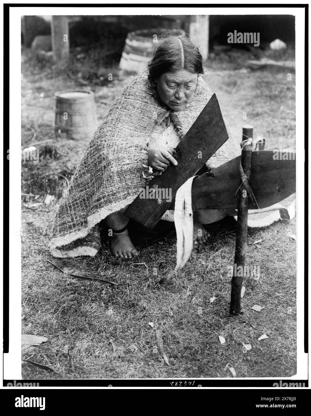 Preparing cedar bark Nakoaktok, Edward S. Curtis Collection., Curtis no. 3570., Published in: The North American Indian / Edward S. Curtis. [Seattle, Wash.] : Edward S. Curtis, 1907-30, v. 10, p. 16.. Indians of North America, Arts & crafts, 1910-1920. , Indians of North America, Domestic life, 1910-1920. , Kwakiutl Indians, Domestic life, 1910-1920. , Kwakiutl Indians, Arts & crafts, 1910-1920. , Indians of North America, Clothing & dress, 1910-1920. , Kwakiutl Indians, Clothing & dress, 1910-1920. Stock Photo