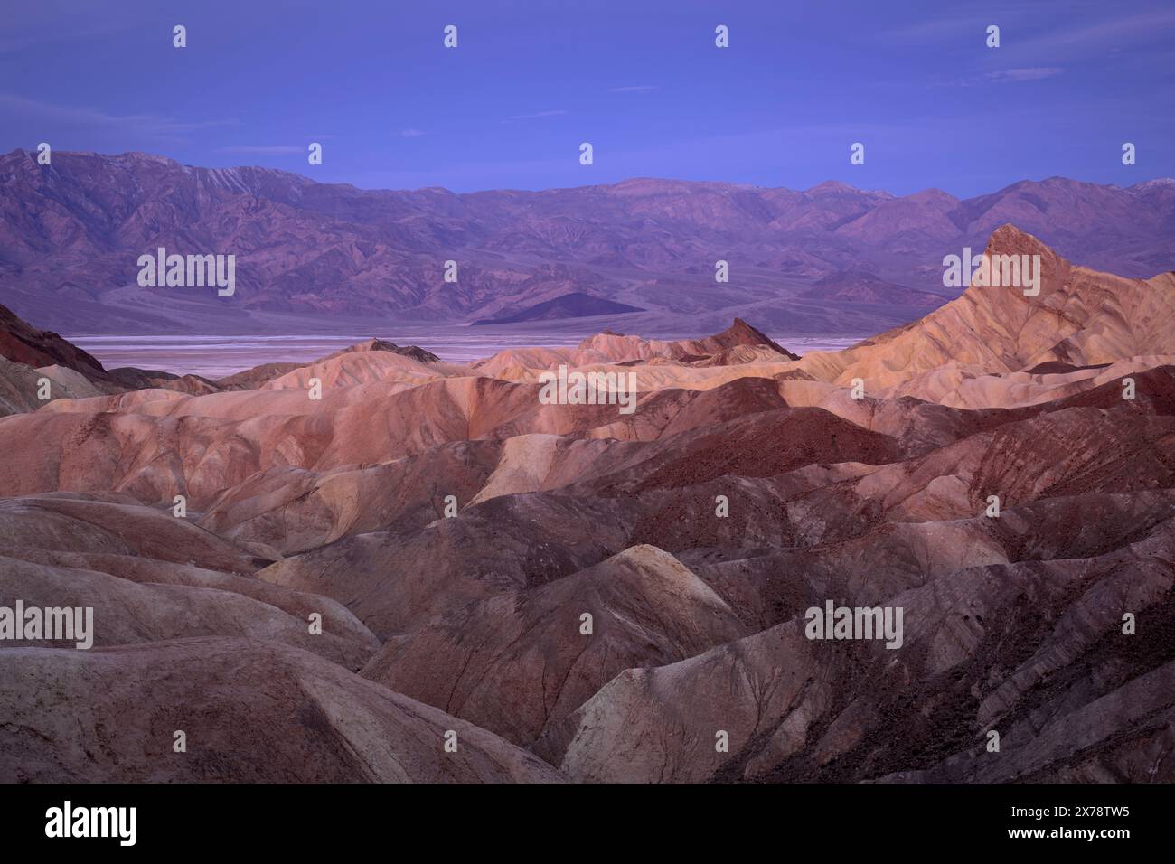 Zabriskie Point badlands, Manly Beacon, Badwater Basin and the Panamint Mountain Range, Death Valley National Park, California. Stock Photo