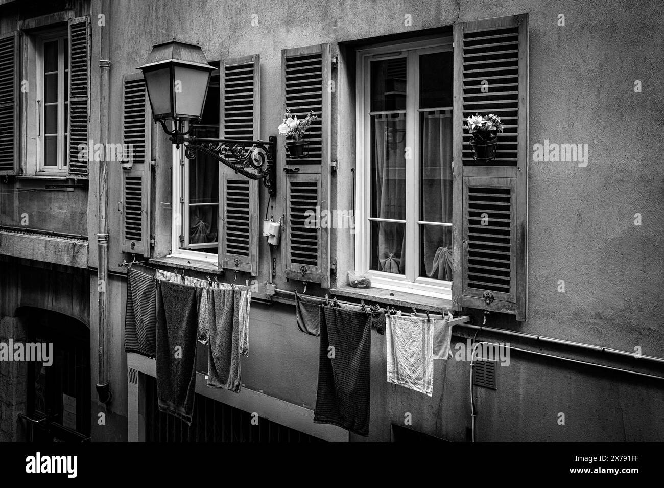 Traditionall apartment facade on a street in Old Town, Vieille Ville in Nice, French Riviera, South of France. Typical French Lifestyle. Black & White Stock Photo