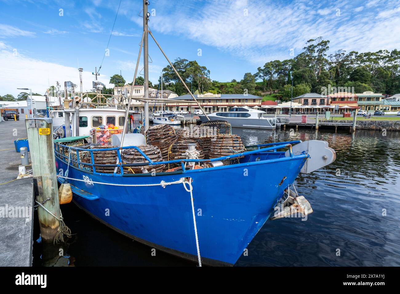 Fishing boats tied up at Strahan town wharf, Strahan, West Coast Tasmanai Stock Photo