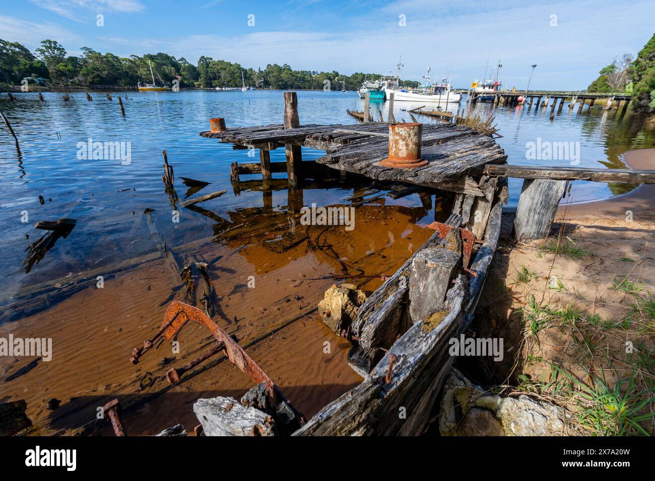 Remains of wooden timber barges abandoned and rotting in Risby Cove, Strahan, West Coast Tasmania Stock Photo