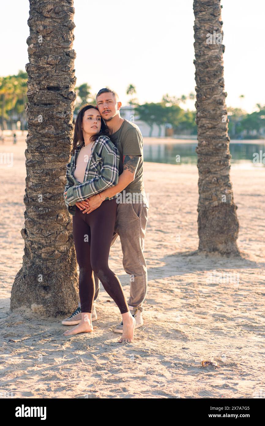 A couple in love hugs on the sea beach. A man and a woman enjoy each other and their vacation by the sea. Stock Photo