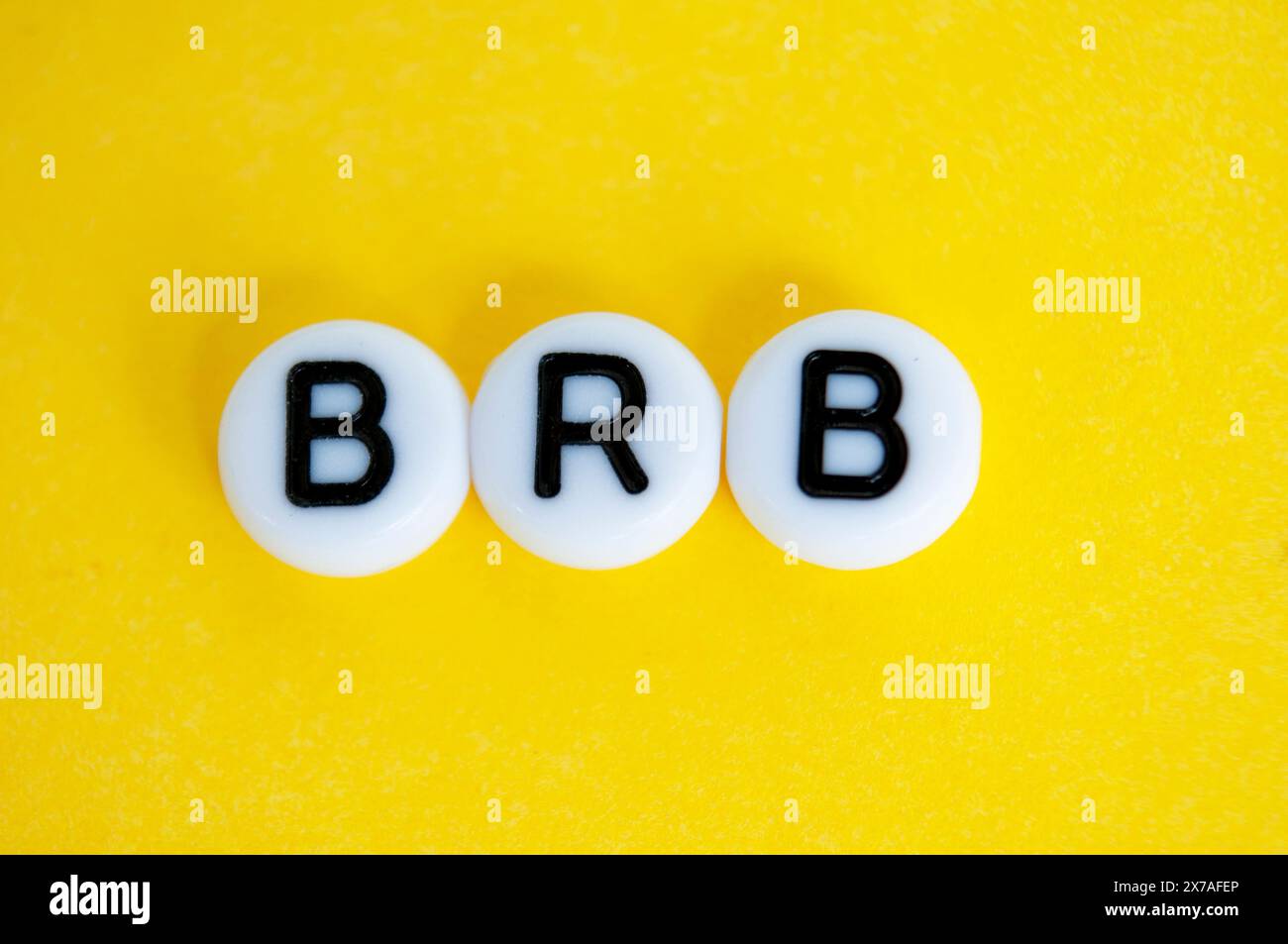 Be right back text on yellow background Stock Photo