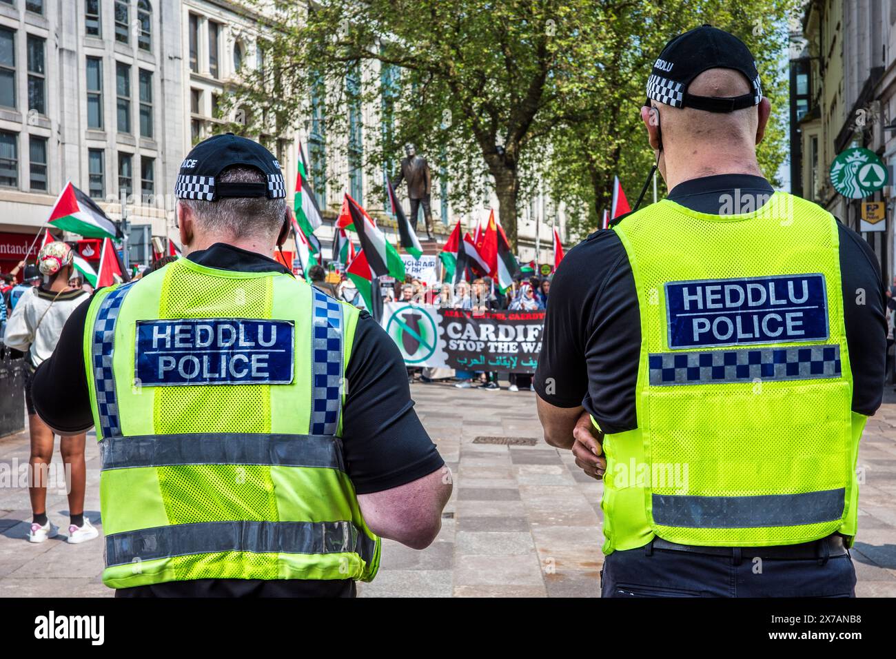 Two police officers watching a Pro-Palestine Protesters in an Anti