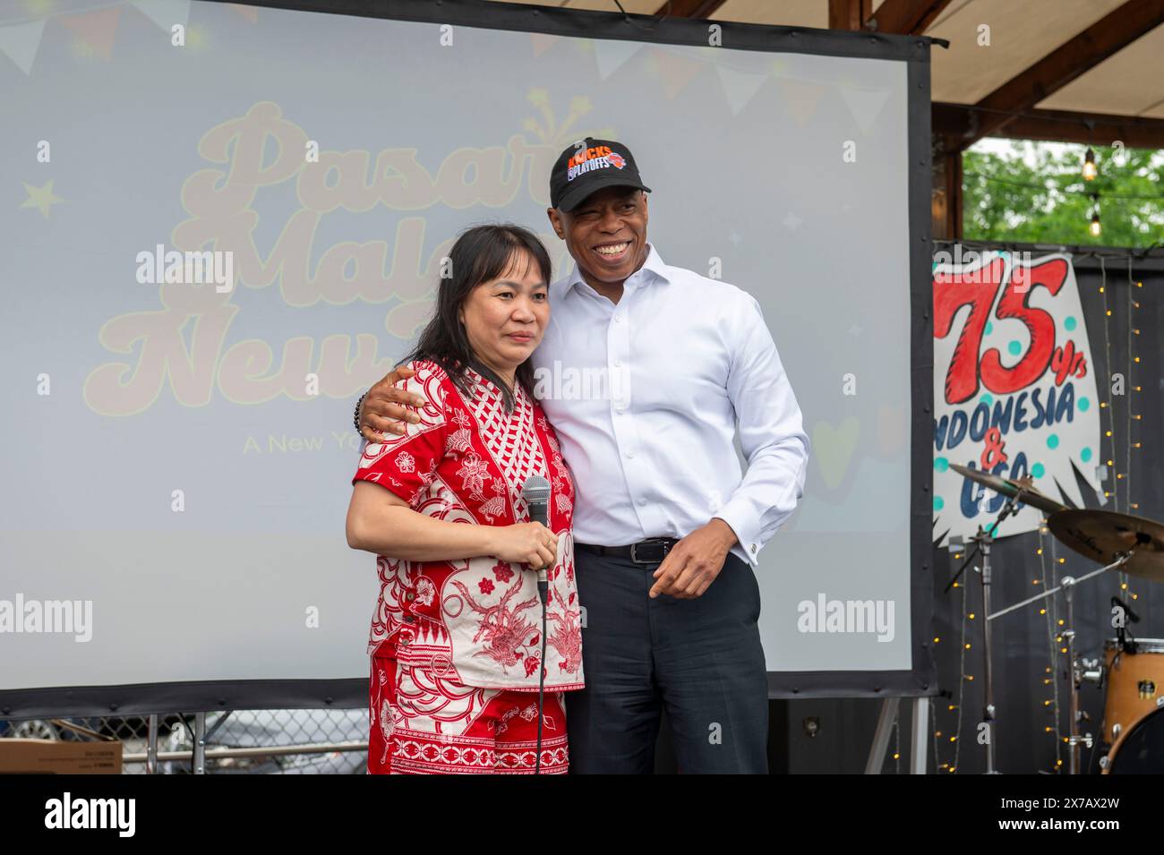 New York City Mayor Eric Adams (R) and Fefe Anggono (L) delivers