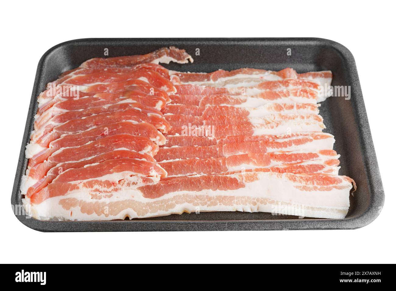 Raw pork bacon in black plastic pack isolated on white background. Streaky brisket slices, fresh thin sliced bacon, food ingredient Stock Photo
