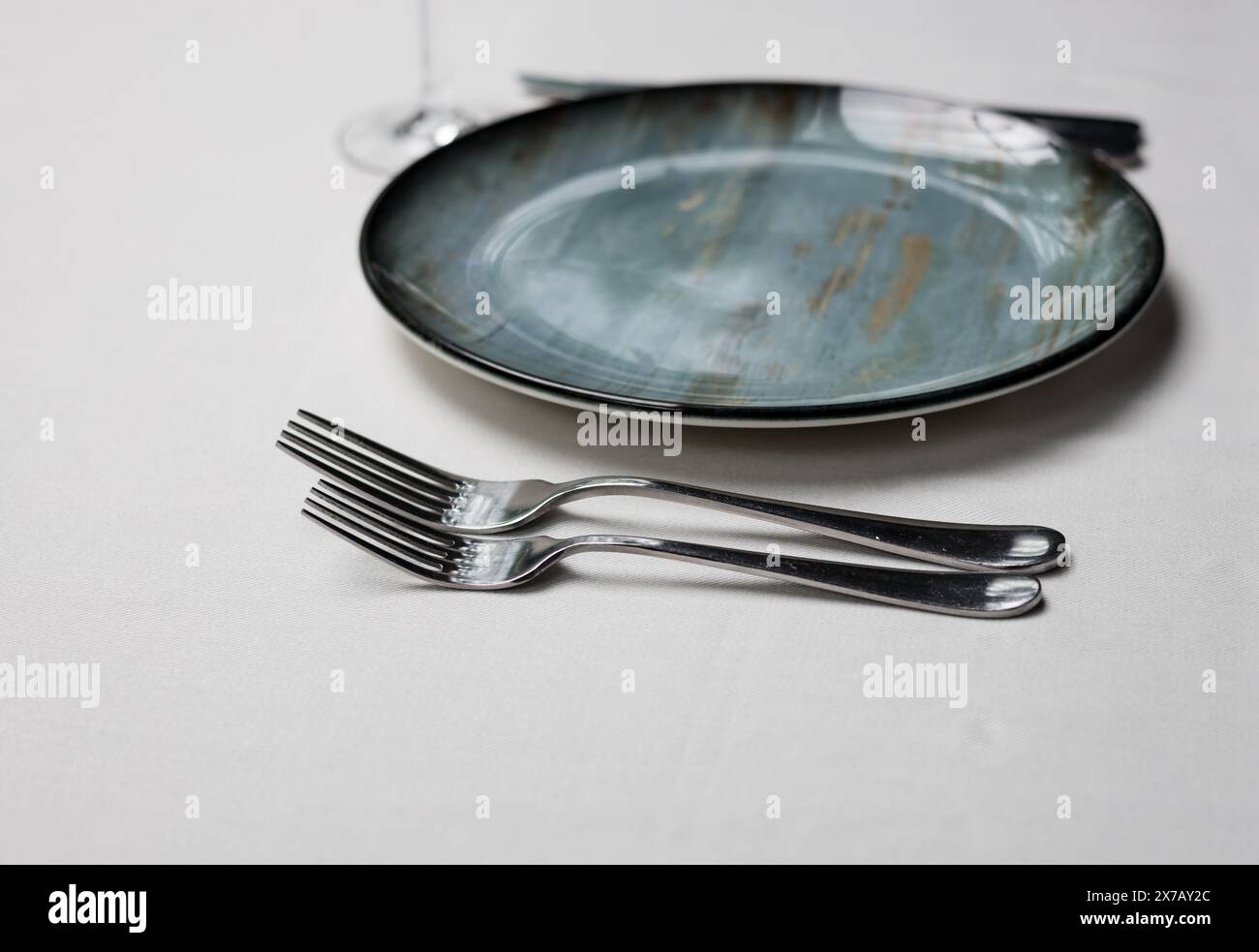 Table service set on the table. plates and fork. elegantly set table. Stock Photo