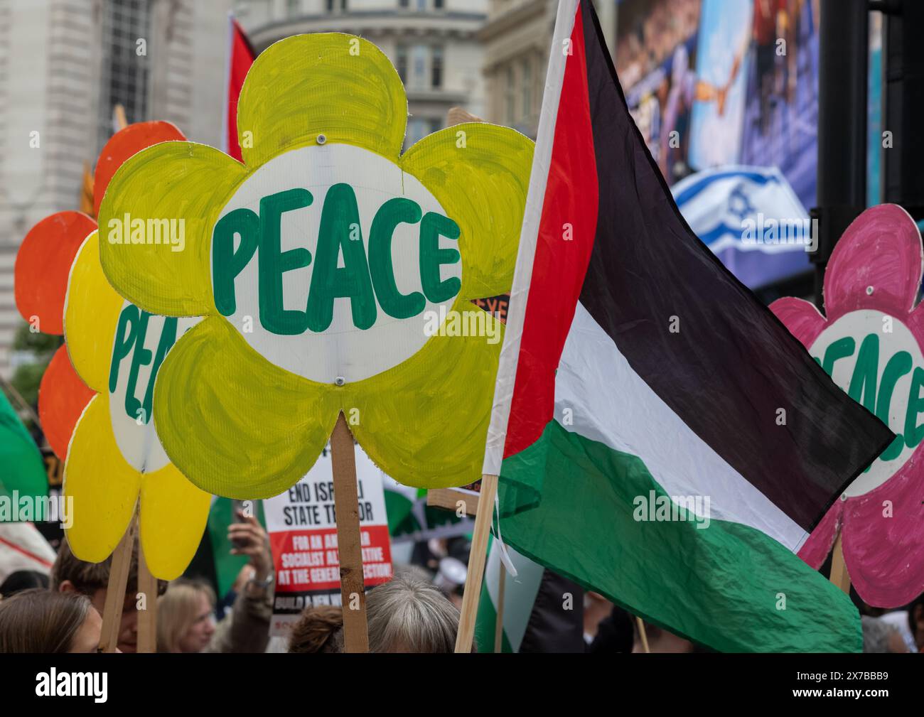 London, UK. 18 May 2024: Placards calling for peace next to a Palestinian flag at the Nakba 76 March for Palestine against Israeli attacks on Gaza in central London, UK. A huge march marked the 76th anniversary of the 'Palestinian Catastrophe' in 1948 and called for a ceasefire in Gaza. Stock Photo