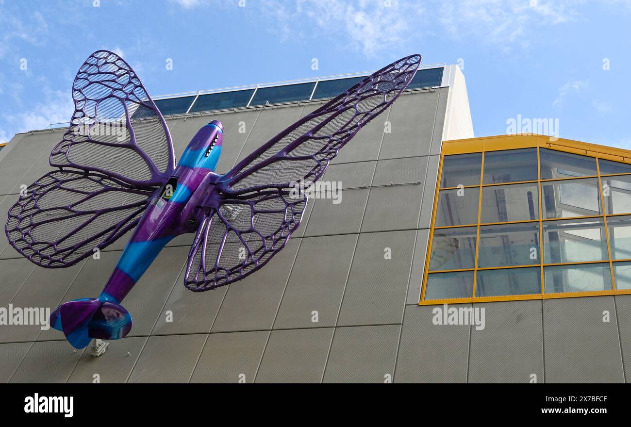 Prague, Czech Republic. 19th May, 2024. Installation of artworks on the facade of renovated Maj department store on 19 May 2024, Prague, Czech Republic. The author of two several-metre-long moving sculptures of butterflies, whose fuselages are imitations of spitfire fighters, is Czech artist David Cerny. They are to become a tribute to Czechoslovak pilots who fought in the Second World War. The civic association Klub za starou Prahu (Club for Old Prague) disagrees with the placement, saying it is typical kitsch. Credit: Katerina Sulova/CTK Photo/Alamy Live News Stock Photo