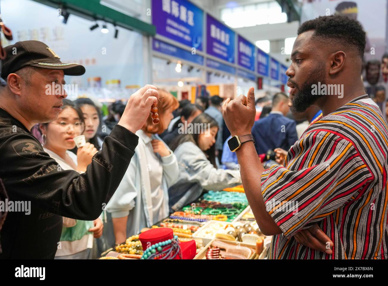 Harbin, China's Heilongjiang Province. 19th May, 2024. People communicate at the Ghanaian booth during the 8th China-Russia Expo in Harbin, northeast China's Heilongjiang Province, May 19, 2024. The expo's activities are being held in Harbin, the capital city of Heilongjiang, from May 16 to 21. Over 5,000 overseas buyers registered at the expo and representatives from 44 countries and regions participated in the expo. Credit: Wang Jianwei/Xinhua/Alamy Live News Stock Photo