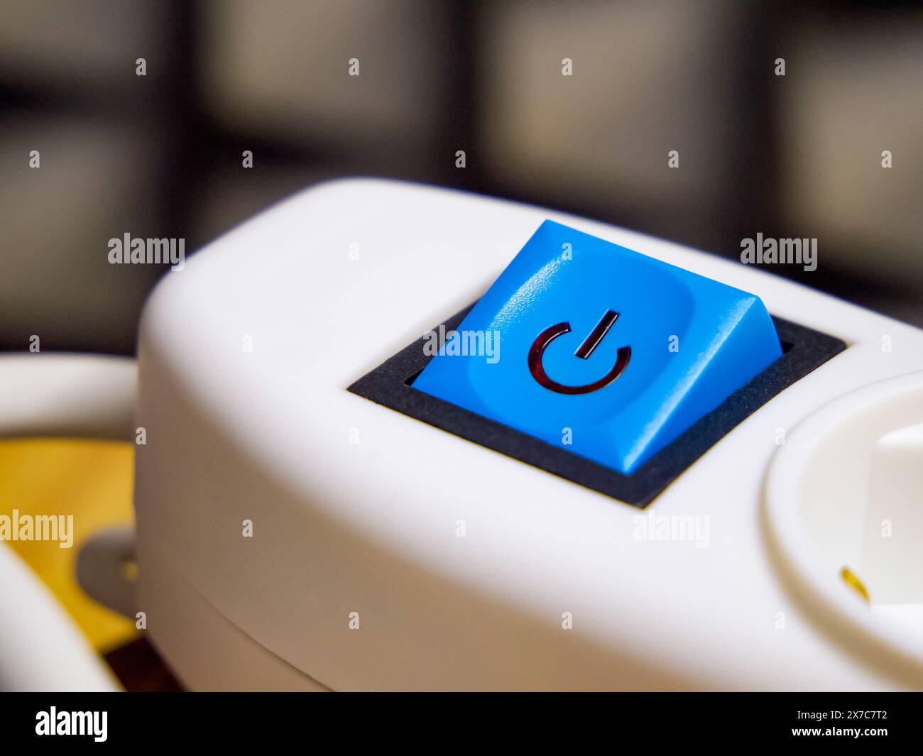 Close-up of a blue button, icon, on white equipment, indicating operation and control. Stock Photo