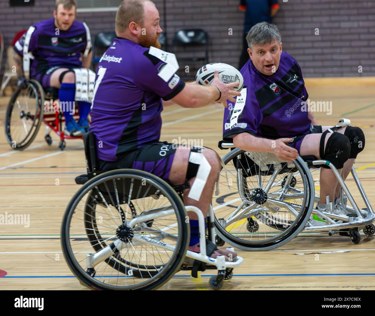 Brentwood Essex 19th May 2024 Wheelchair Rugby League: Brentwood Eels (Stripped shirt, yellow tags) vs Team Colostomy UK (Purple shirts, white tags) at the Brentwood Centre, Brentwood Essex UK Credit: Ian Davidson/Alamy Live News Stock Photo