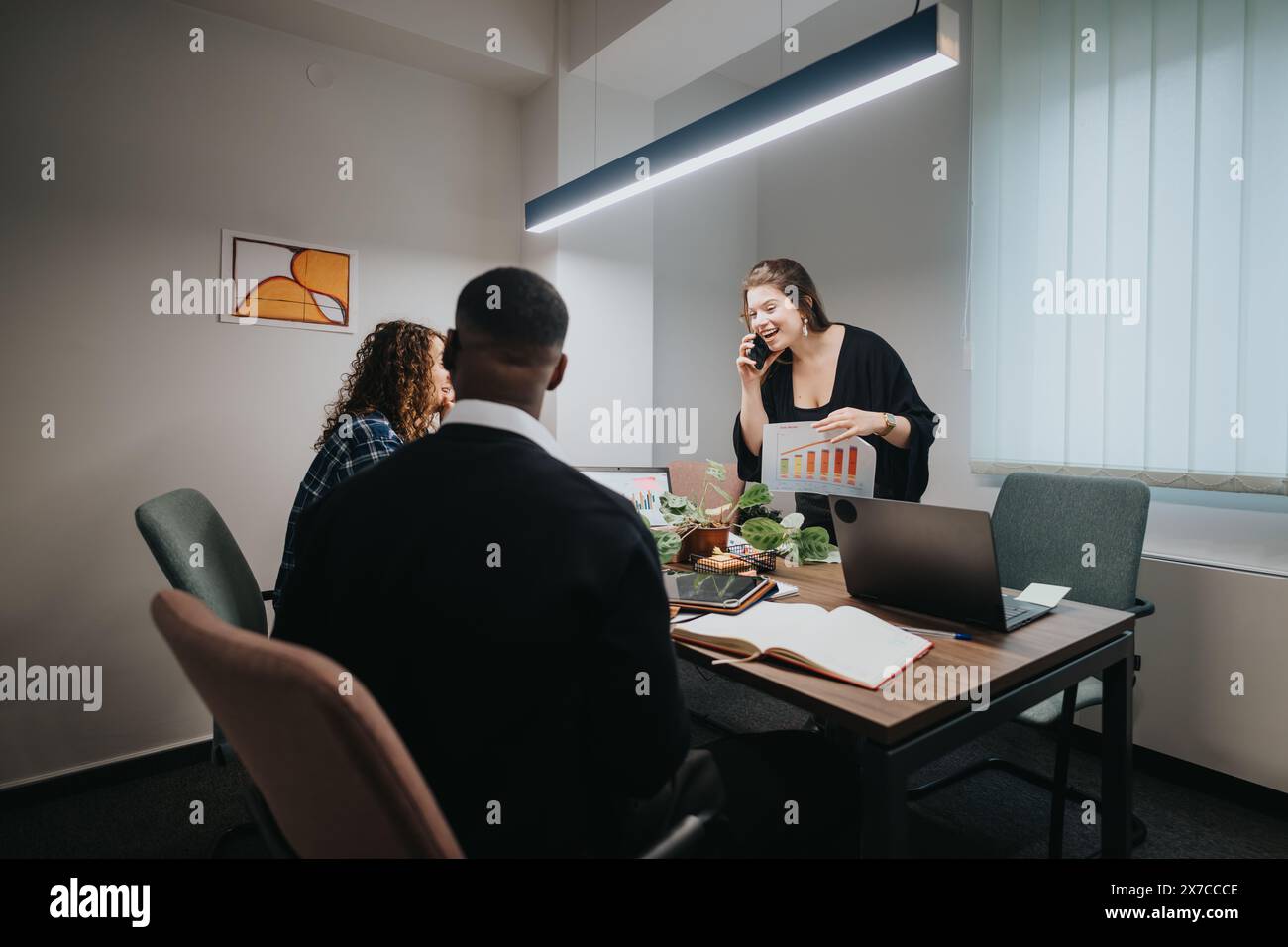 Multicultural team analyzing growth statistics together in a modern office Stock Photo