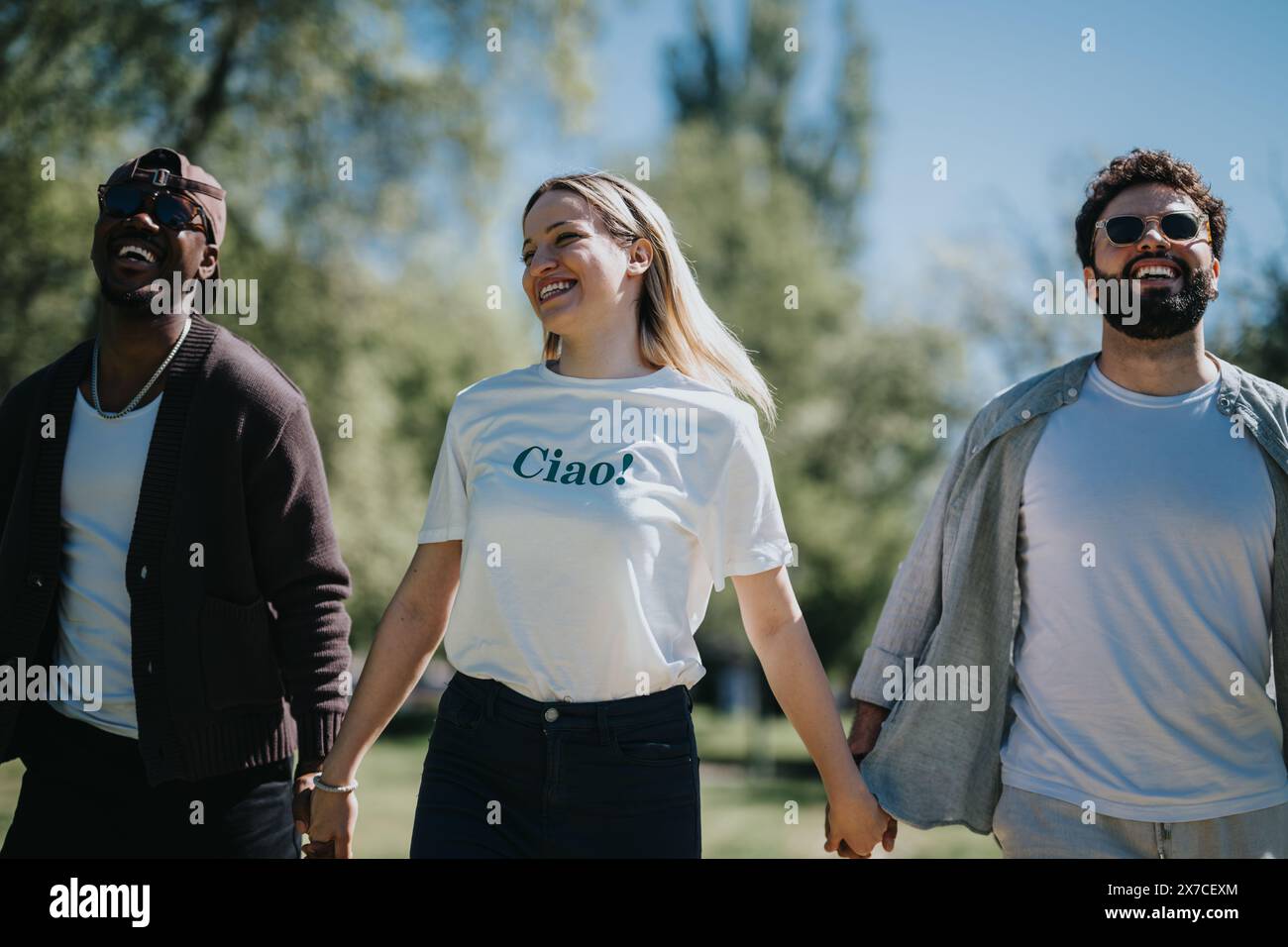 Carefree friends enjoying sunny day in the park with laughter and ...